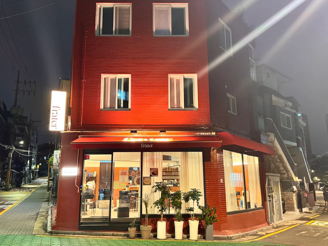 Frater's red-brick exterior at night