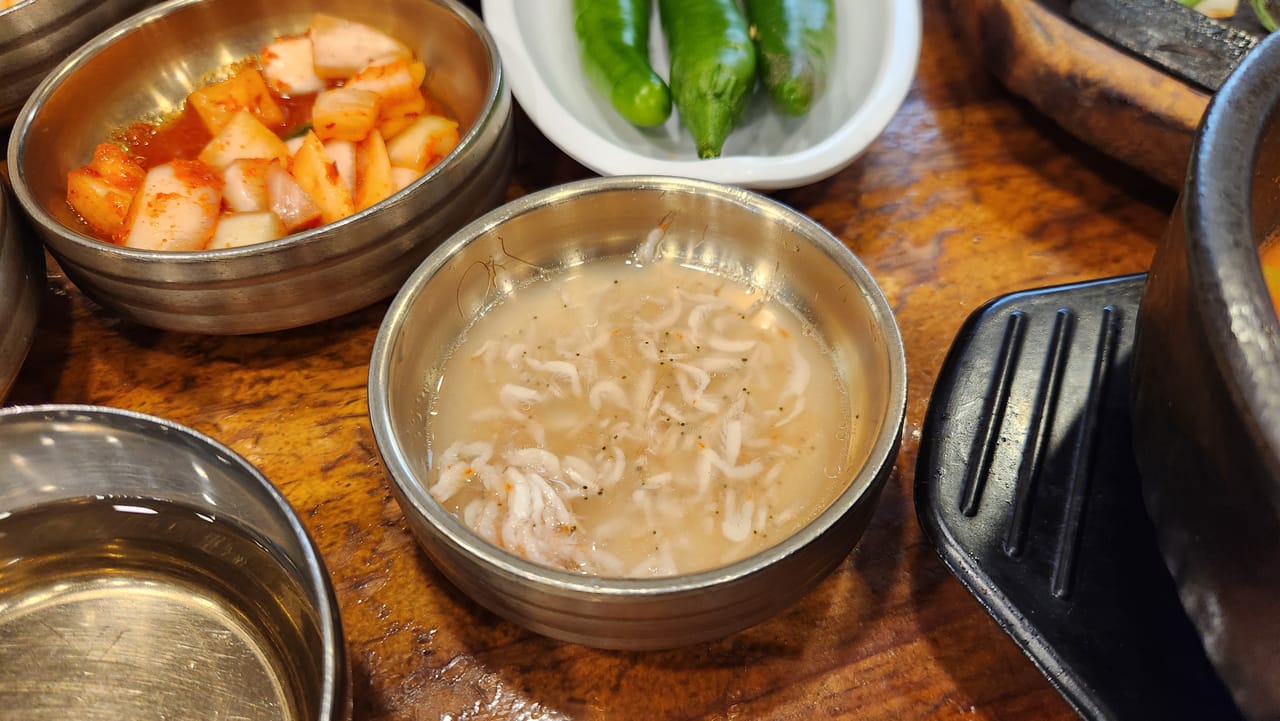 Korean saeujeot salted fermented shrimp condiment beside kkakdugi