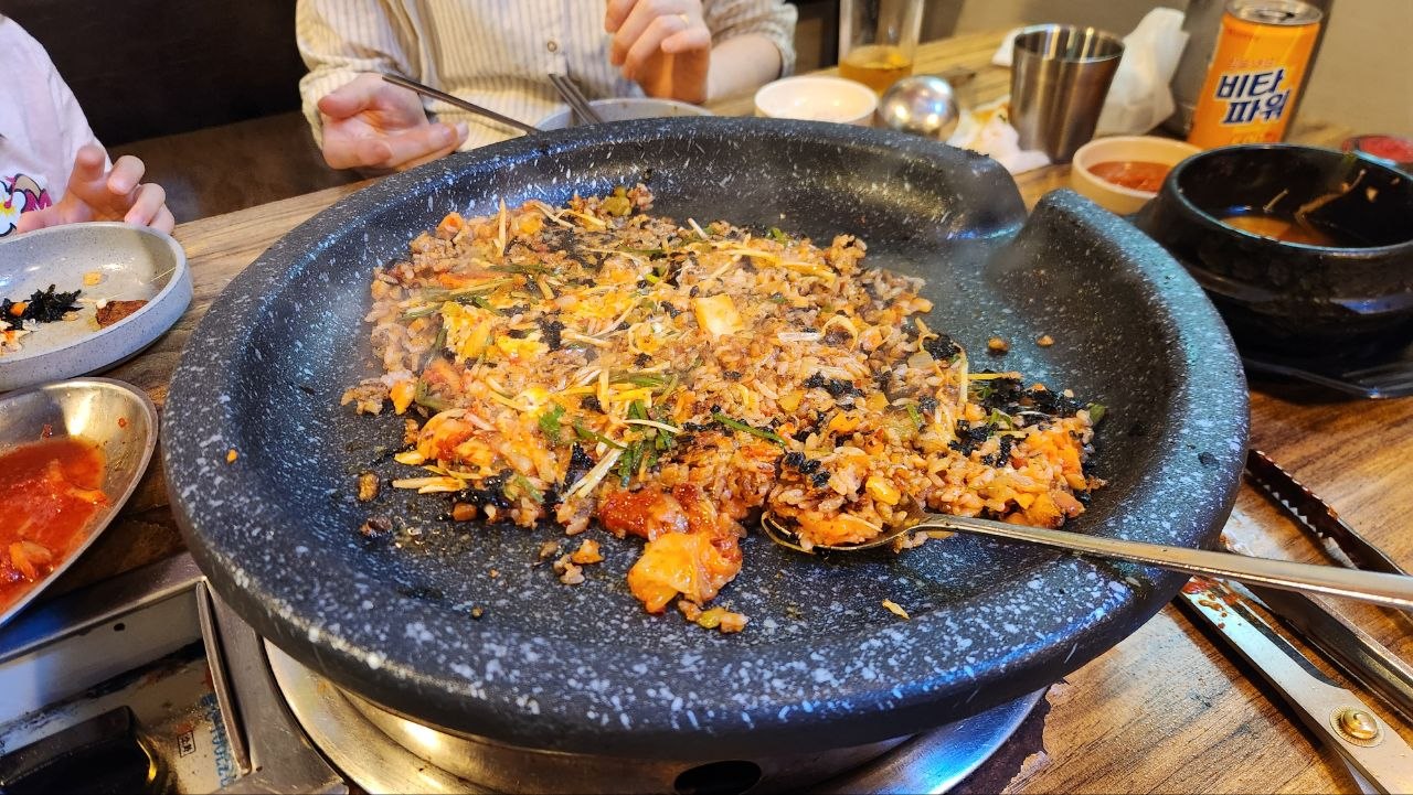 Kimchi fried rice with seaweed spread across the Korean barbecue pan
